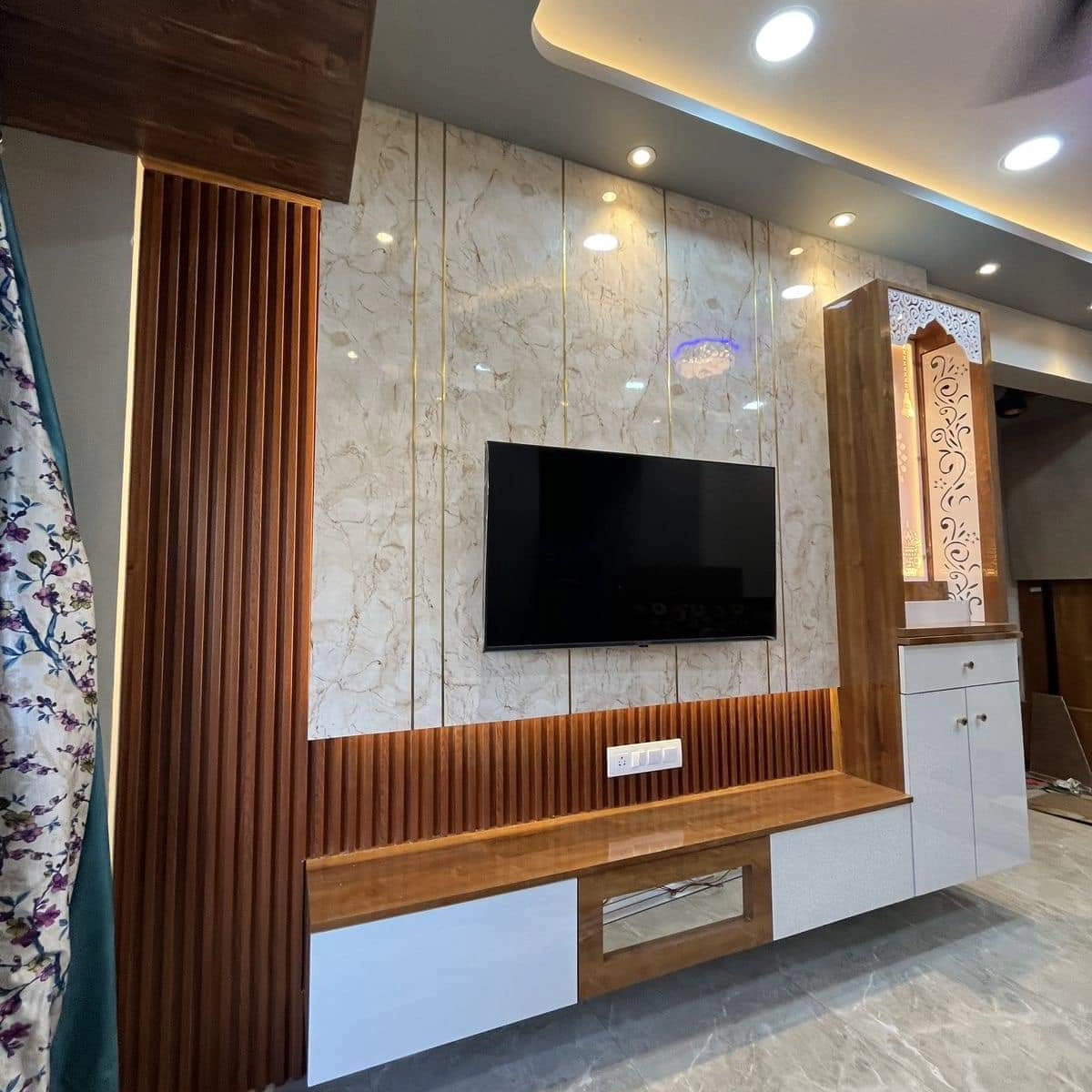 TV wall unit with wooden fluted panels and pooja niche